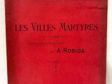 un livre rouge avec des caractères noirs, posé sur une table