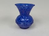 a blue vase that is sitting on a table