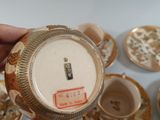 a person holding a cup and saucer in their hand