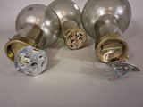 three different types of door knobs on a white surface