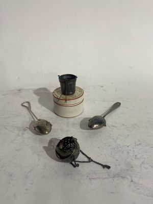a few spoons and a cup on a table