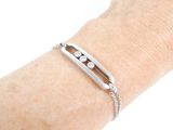 bracelet on a woman ' s arm with a chain around it