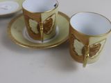 three cups and saucers sitting on a white table