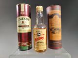 three bottles of whiskey on display on a shelf