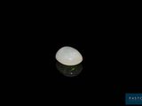 a close up of a white stone on a black surface