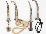 three knives and a pair of scissors on a white surface