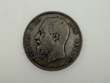 a silver coin with a man ' s face on it