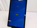 an ipad with a blue screen sitting on top of a white table