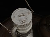 a small white light that is on top of a metal container