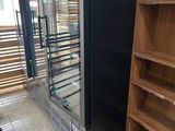 a refrigerator that is sitting in a store with shelves