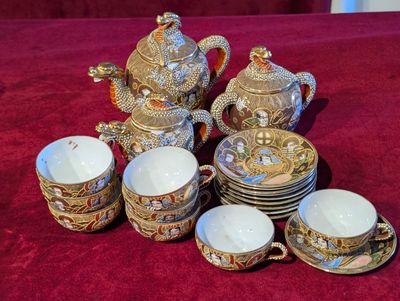 many cups and saucers that are on a table