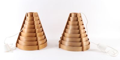 two wooden lamps that are on a white surface
