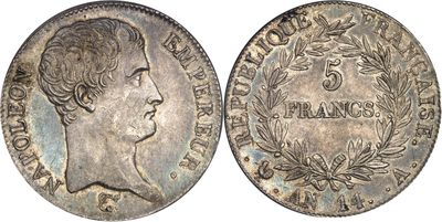 a silver coin with a woman ' s head and laurels on it