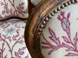 a close up of a chair with a floral pattern on it
