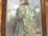 painting of a young girl in a green dress in a frame on a wooden floor