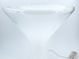 a glass vase with a mouse in it on a table