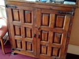 a wooden cabinet with a mirror on top of it