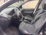 the interior of a small car with black seats and a steering wheel