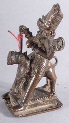 a statue of a woman riding a horse with a basket on her back