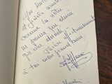a handwritten note in a book on a wooden table