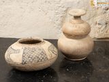 two vases that are sitting on a table