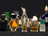 many different types of perfume bottles lined up on a table
