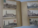 a person holding an open book with pictures of buildings on it