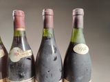 several bottles of wine are lined up on a table