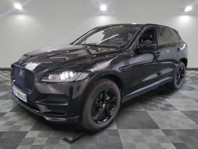 the black jaguar suv is parked on a checkered tile floor