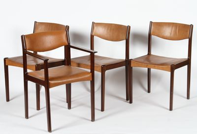 three wooden chairs with brown leather seats against a white wall