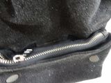 a close up of a black purse with a zipper on it