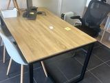 a desk with two chairs and a computer on it
