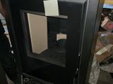 a black cabinet with a glass door in the middle of it