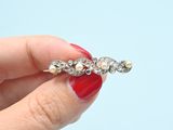 a woman holding a diamond ring in her right hand