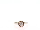 a close up of a diamond ring on a white surface
