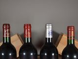 three bottles of wine are lined up in a row on a table