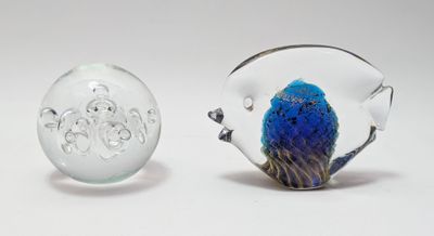 two glass figurines that are sitting next to each other