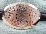 a close up of a belt with a silver buckle on it