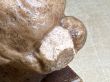 a statue of a man that is sitting on a table
