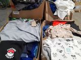 several boxes of clothing are stacked on top of each other in a warehouse