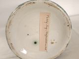 a close up of a white plate with a tag on it