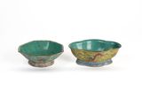 pair of green and blue bowls with designs on them on a white surface