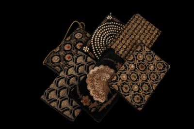 several different types of purses are arranged on a black surface