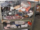 a metal cart with many items in it in a warehouse