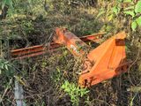 an orange plow sitting in the middle of a field