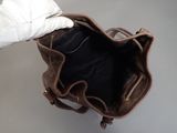 a person holding a brown purse in their hand