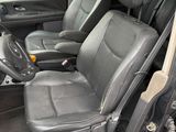 the interior of a car with the door open and the passenger seat down