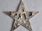 a close up of a metal star on a white surface