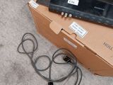 a box with wires and a remote on the floor