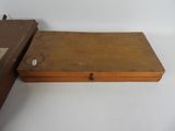 two wooden boxes sitting on top of a white table